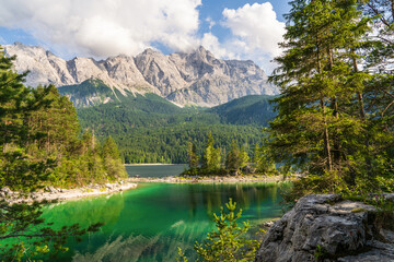Eibsee lake with clear turquoise water, surrounded by Bavarian Alps near Zugspitze mountain, Germany. Scenic nature landscape, perfect for travel, hiking.