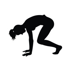 Silhouette of a woman performing a yoga pose called bear crawl
