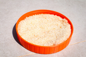 Top view of sugar under the sun on the floor.