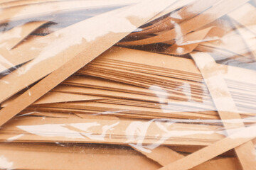 A close-up photo of brown shredded paper inside a plastic bag.