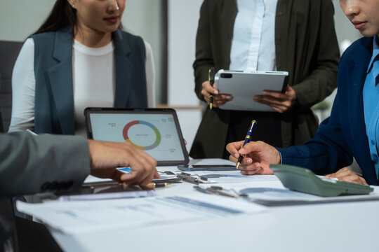 Entrepreneurs, marketers, managers, and financial analysts gather around the table to analyze data, present results, plan strategies, discuss efficiencies,grow their businesses through collaboration