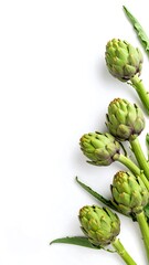 Obraz premium Fresh artichoke heads arranged on white background