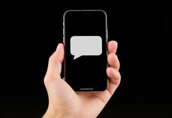 Mobile Phone in Hand Displaying Text Message Bubble on Dark Background for Communication and Technology Themes
