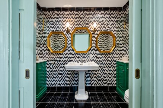 Eclectic Bathroom Design with Bold Patterned Wallpaper and Hexagonal Mirrors