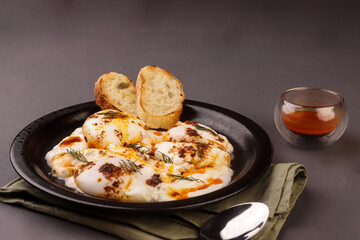 Cilbir or Turkish Eggs is Poached Eggs With Creamy Yogurt and Butter Sauce. 