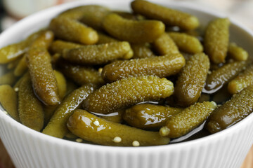 Tasty pickled cucumbers in bowl, closeup