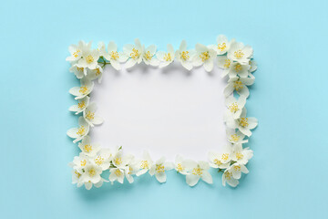 Blank card with beautiful jasmine flowers on blue background