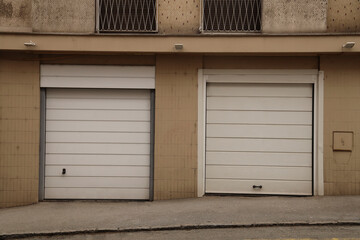 2 two Hangars garage exterior grey with sectional gray gate or closed shop rolling shutters of new building. Belgrade Serbia. Real estate Exterior house home