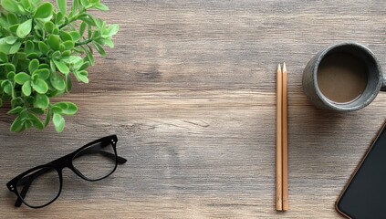 Wooden desk, coffee, plant, glasses, pencils, phone