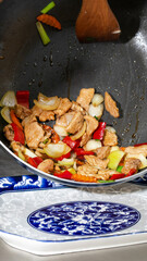 Stir-fried symphony of vibrant veggies and juicy chicken, evoking Lunar New Year's culinary dance and abundance spirit
