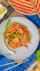 Shrimp-laden Pad Thai, vibrant umami feast, Lunar New Year table, delicate aromas dance, Thai culinary tradition ignites taste