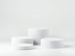 Minimalist white pedestals arranged on a white surface with soft lighting