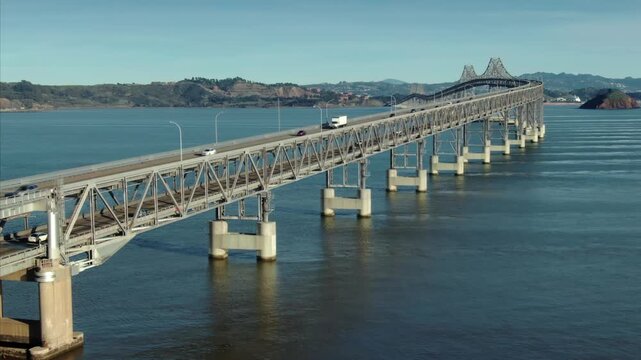 Cars and trucks travel across the Richmond-San Rafael Bridge, connecting Contra Costa and Marin counties in California, USA. San Quentin.