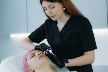  an aesthetic professional performing an injection procedure. Beauty treatment