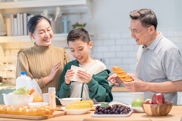 Warm moment at home, together, parenting, greeting, happiness, Christmas greeting season lifestyle tradition, joyful scene of child and grandparents sharing time in kitchen, New Year holiday festive