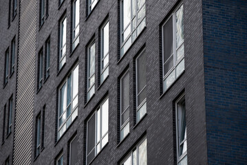 empty glass windows of a modern building with a reflection of the sky in the glass