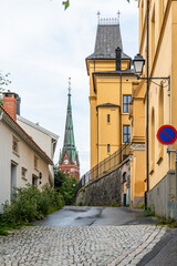 Trefoldighetskirken in Arendal in Norway seen from a small street between houses