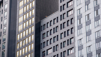 Fototapeta premium empty glass windows of a modern building with a reflection of the sky in the glass