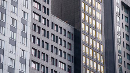 empty glass windows of a modern building with a reflection of the sky in the glass