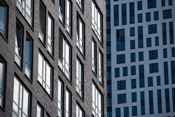 Fototapeta premium empty glass windows of a modern building with a reflection of the sky in the glass