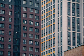 empty glass windows of a modern building with a reflection of the sky in the glass