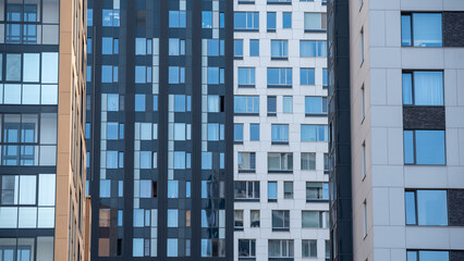 empty glass windows of a modern building with a reflection of the sky in the glass