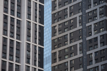 Fototapeta premium empty glass windows of a modern building with a reflection of the sky in the glass