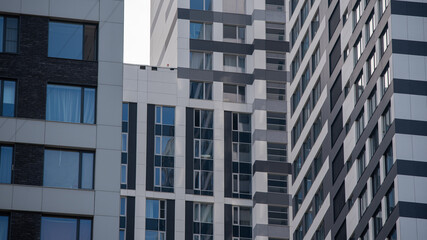 empty glass windows of a modern building with a reflection of the sky in the glass