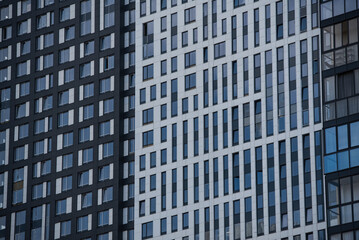 Fototapeta premium empty glass windows of a modern building with a reflection of the sky in the glass