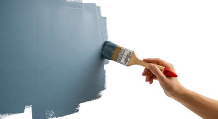 Hand holding paintbrush applying blue paint to textured surface painting transparent background