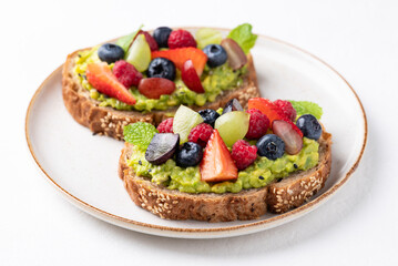 Avocado toast with strawberry, blueberry, raspberry and grape. Healthy eating