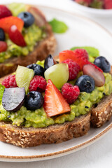 Avocado toast with strawberry, blueberry, raspberry and grape. Healthy eating