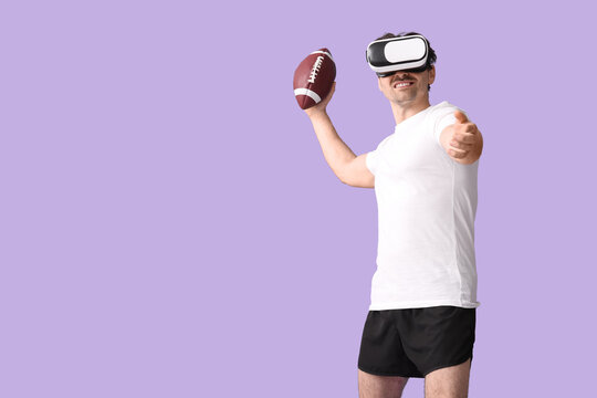 Sporty young man in VR glasses with rugby ball on lilac background