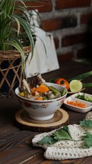 soup with vegetables isolated on wooden background