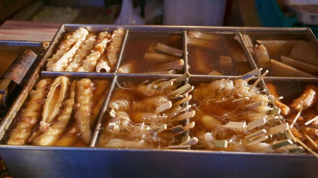 Close up of traditional Japanese oden stall at a street food market, in Kyoto, Japan