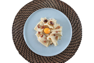 Isolated plate of Walnut alla Carbonara Pasta with sous vide poached egg
