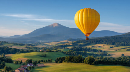 Obraz premium Yellow hot air balloon flying over scenic countryside
