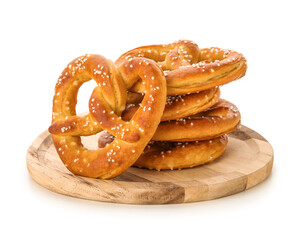 Wooden plate with tasty salted pretzels on white background