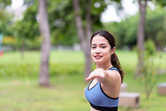 Beautiful young women practicing yoga at park in the morning