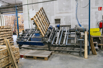 Automated machinery processing wooden pallets in a recycling factory, promoting sustainability and resource efficiency in the timber industry