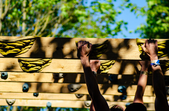Hands Gripping Holds on a Climbing Training Board. Concept The power of grip.
