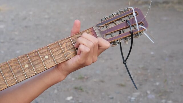 male hands playing guitar close up