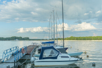 Fototapeta premium Modern motorboat gliding across tranquil waters. A stylish motorboat inviting adventure and relaxation on serene lakes. The allure of a modern motorboat reflecting dreams of nautical escapades.