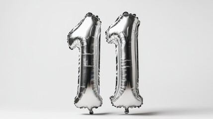 Silver number 11 balloons against a minimalist white background