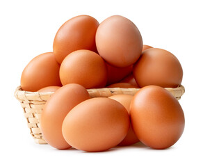 Many brown chicken eggs in stack in wicker basket isolated on white background with clipping path