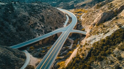Elevated Highway Intersection in Canyon: Aerial View, Dramatic Lighting, Serene Landscape.