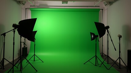 Professional photography studio setup with green screen and lighting equipment