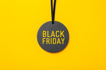 Black friday sale tag on yellow background