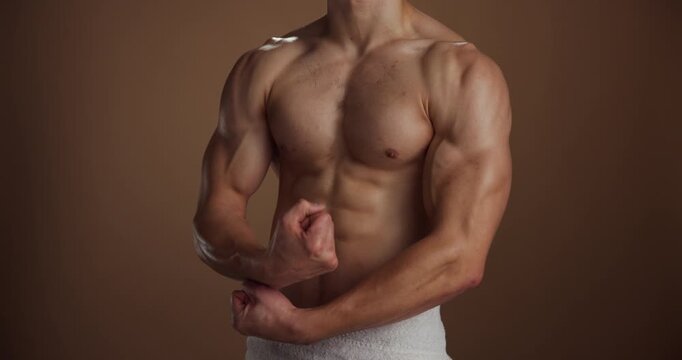 Shirtless, fitness and man in studio, muscular and energy with grooming on brown background. Topless, space and person with health, confident athlete and bodybuilding with pride, pecs and torso
