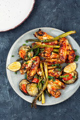 Grilled chicken wings with green asparagus.